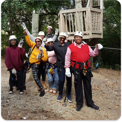 people posing for the camera after completing an aerial adventure course