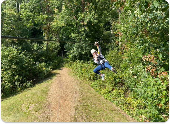 person on a zipline in Kentucky going through the trees