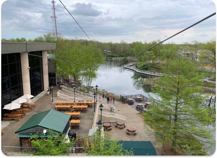 zip line course going over a seating area and pond at Creation Museum