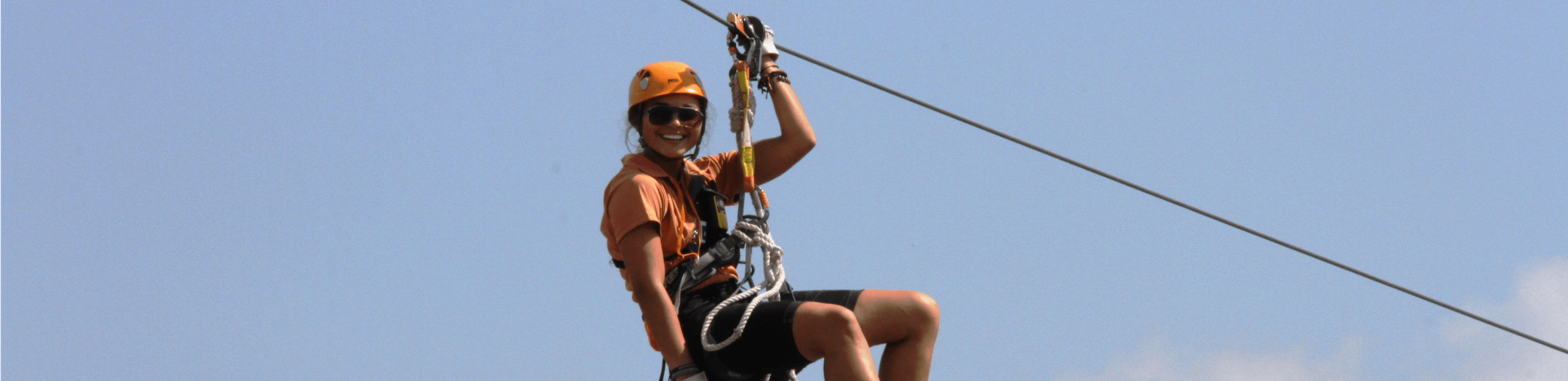 person on zip line smiling for the camera